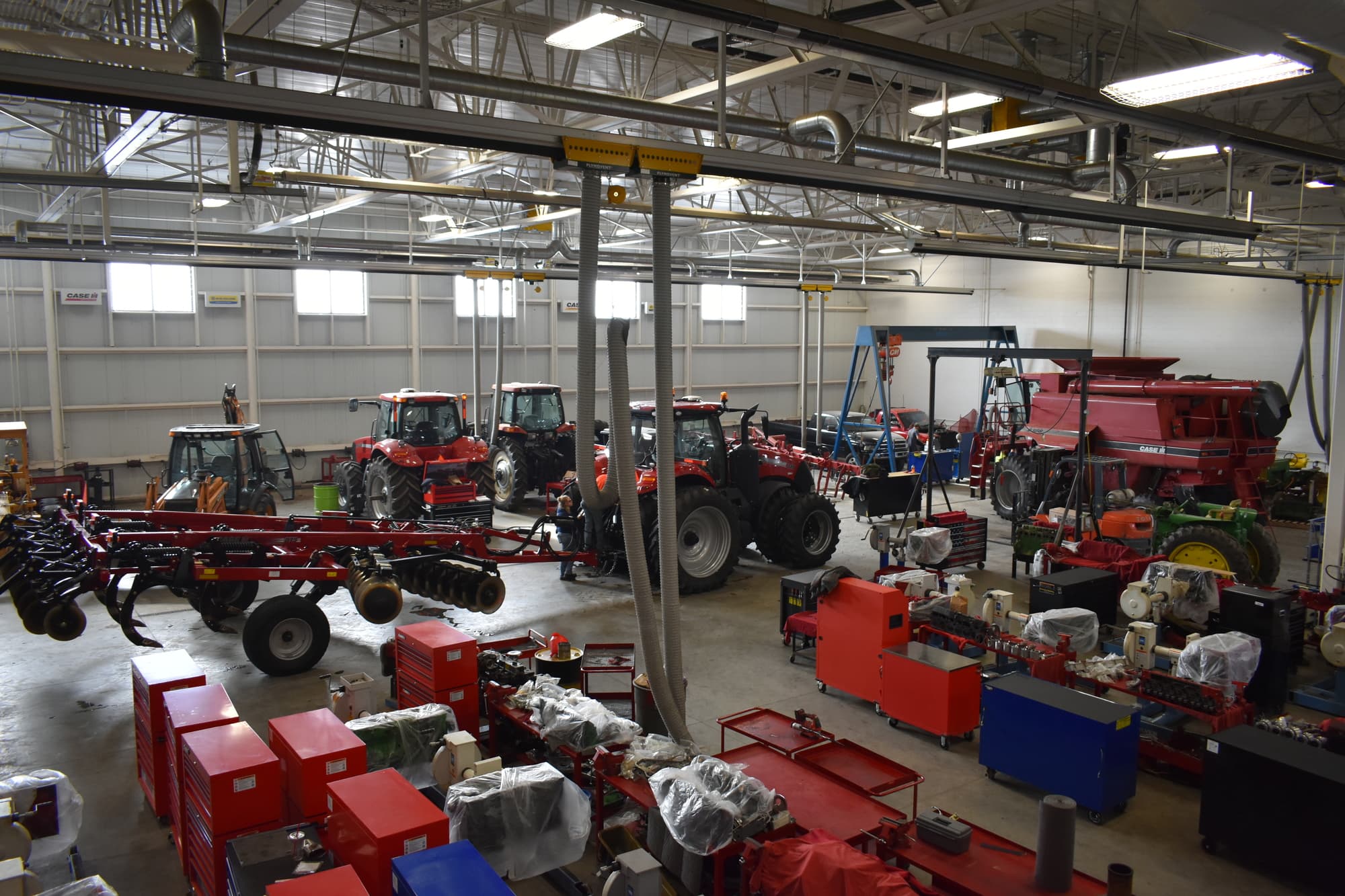 large room filled with tractors and farm equipment